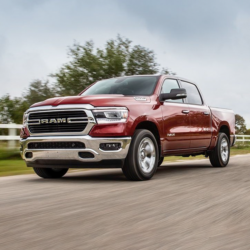 2020 Ram 1500 in red driving down a dirt road
